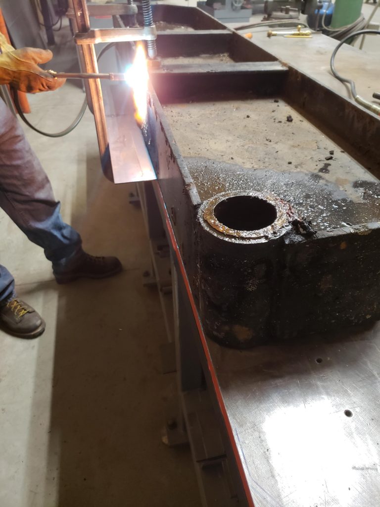 man welding a piece of equipment
