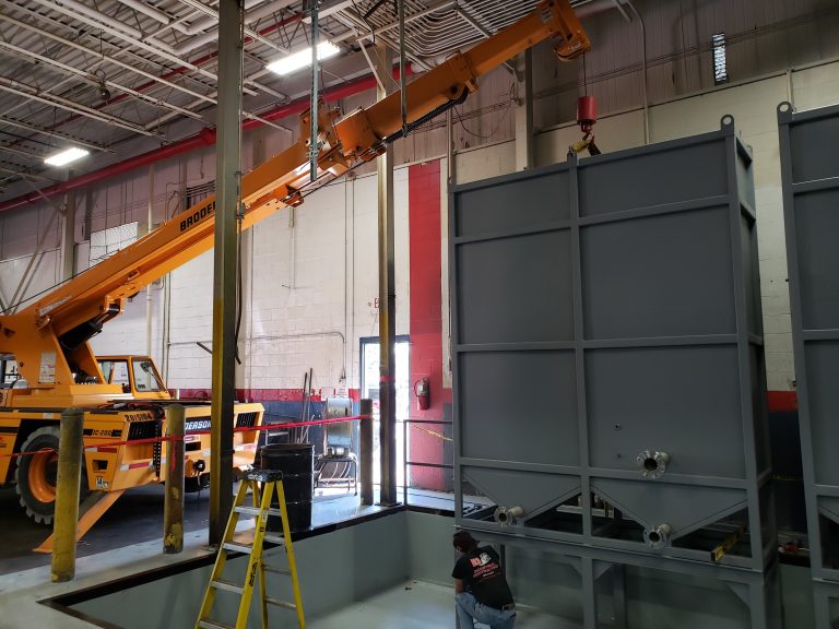 Crane picking up big equipment